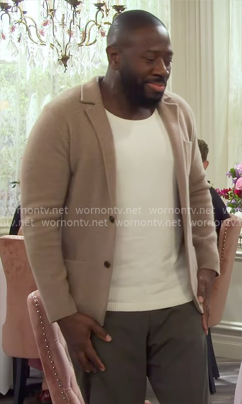 Malcolm's beige knit jacket on The Neighborhood