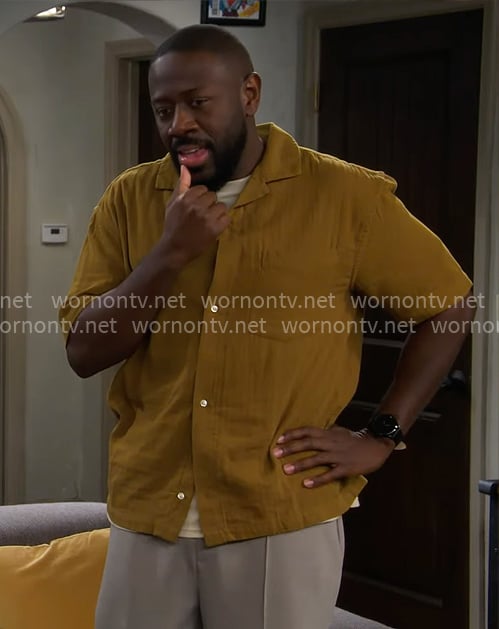 Malcolm's mustard button down shirt on The Neighborhood