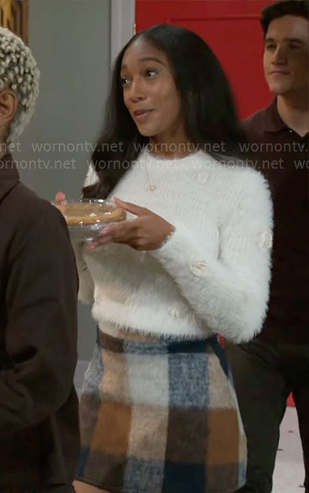 Samantha's white fluffy sweater and checked skirt on Beyond the Gates