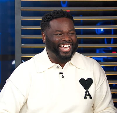 EJ's white polo sweater on Access Hollywood