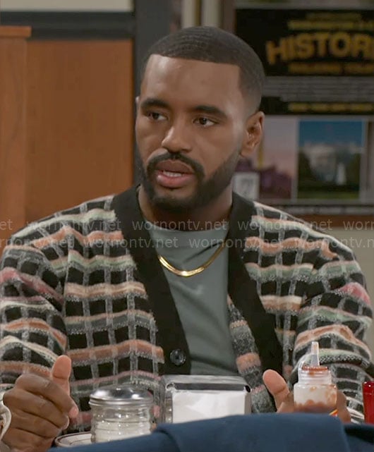 Andre's checked cardigan on Beyond the Gates
