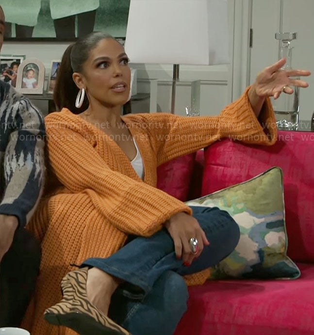 Dani's long orange cardigan on Beyond the Gates