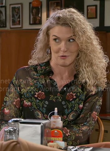 Jan's black floral top on Beyond the Gates