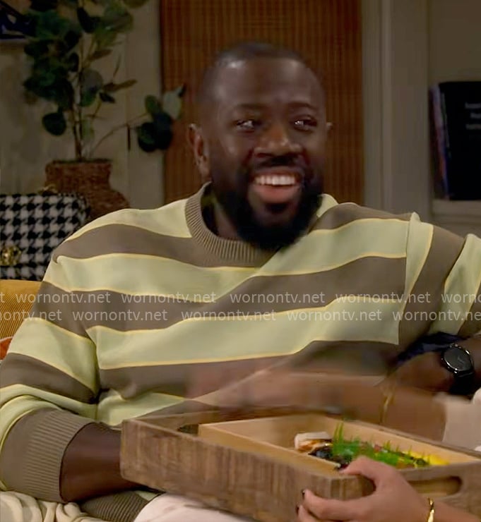 Malcolm's green and brown striped sweater on The Neighborhood