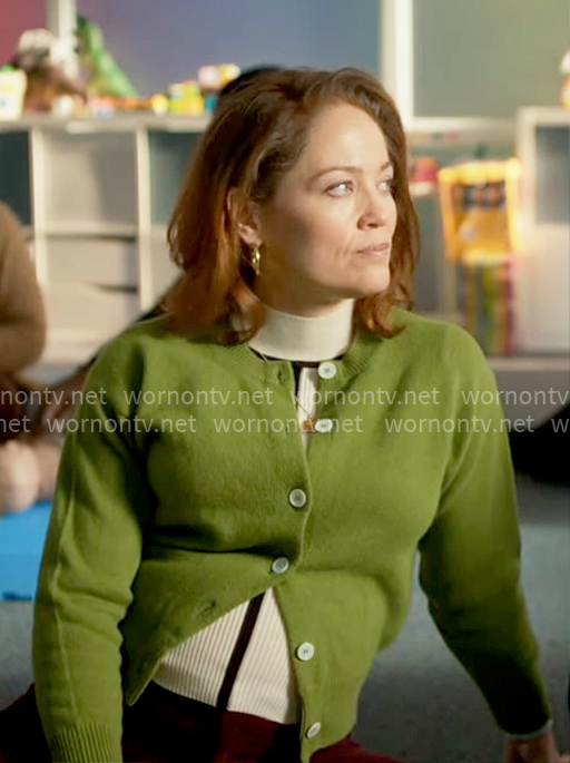 Angie's striped mock neck top and green cardigan on Will Trent
