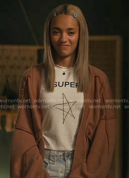 Ava's Super Star tee and orange cardigan on High Potential