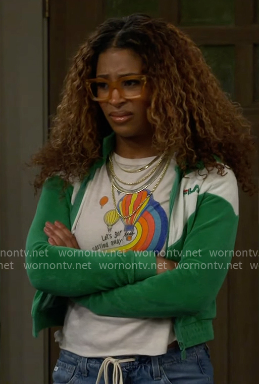 Courtney's balloon graphic tee and green jacket on The Neighborhood