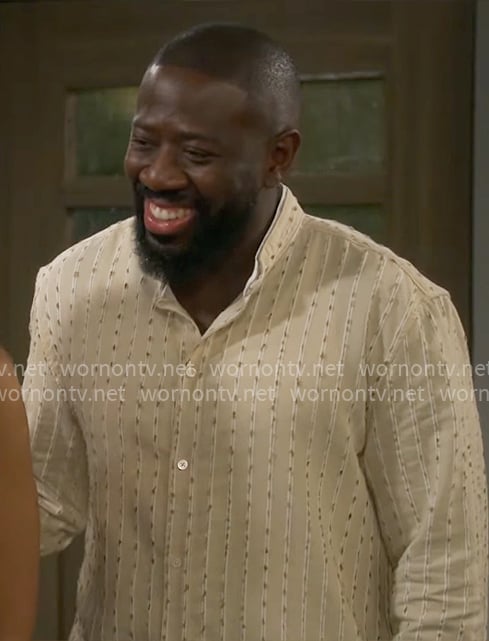 Malcolm's beige striped shirt on The Neighborhood