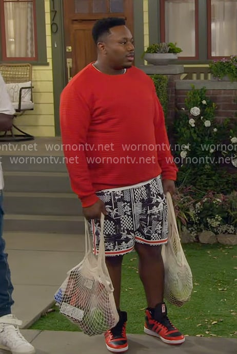 Marty's red sweater and printed shorts on The Neighborhood