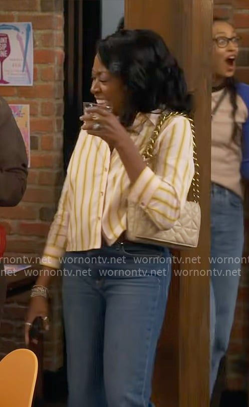 Tina's yellow striped shirt on The Neighborhood