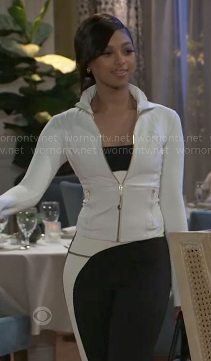 Kat's white jacket with gold zip and two tone leggings on Beyond the Gates
