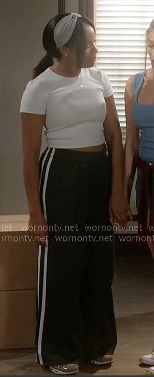Naomi's heathered tee and dark green track pants on Beyond the Gates
