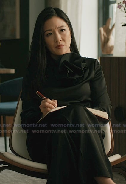 Mallory's black ruffle neck blouse on Elsbeth