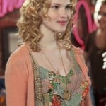 Magnolia’s paisley jumper/romper under a cropped peach rosette cardigan and circle necklace on Hart of Dixie