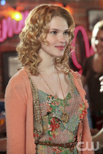 Magnolia’s paisley jumper/romper under a cropped peach rosette cardigan and circle necklace on Hart of Dixie