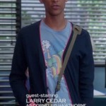 Abed’s light blue rainbow graphic shirt and navy/pink cardigan on Community