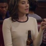 Robin’s cream longsleeve top with black neck trim on How I Met Your Mother