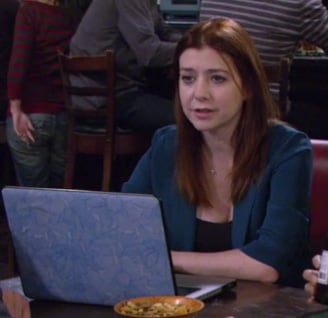 Lily’s teal blue blazer and blue floral laptop cover on How I Met Your Mother