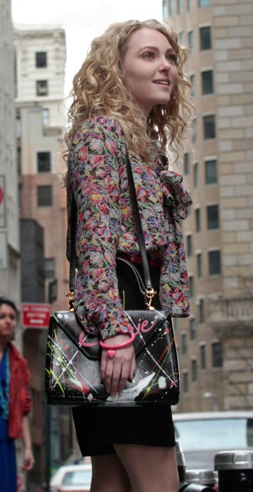 Carrie’s floral blouse with bow and black paint splatter bag on The Carrie Diaries