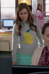 Betsey's grey sweater with yellow pear on The Mindy Project