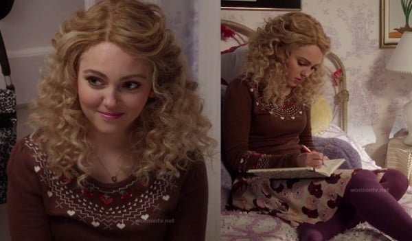 Carrie's brown heart and cherry sweater with purple tights on The Carrie Diaries