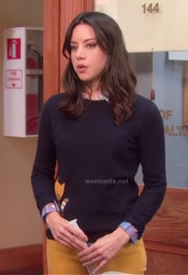 April’s navy sweater with cat on it on Parks & Recreation