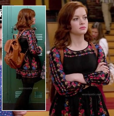 Tessa’s black long sleeved floral dress and tan backpack on Suburgatory