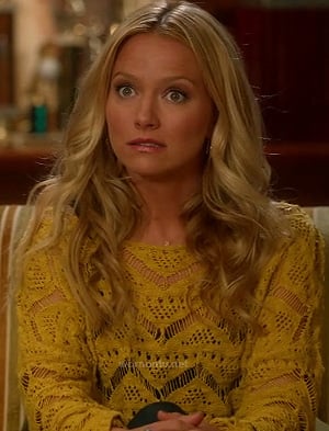 Chloe’s yellow knit sweater on The Goodwin Games