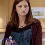 Clara’s blue printed dress and burgundy cardigan on Doctor Who