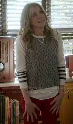 Polly’s grey sweater with white striped sleeves on How To Live With Your Parents
