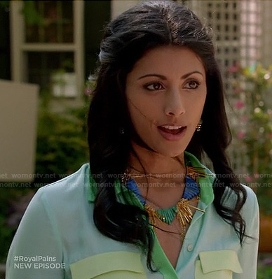 Divya’s pastel colorblock shirt and blue spike necklace on Royal Pains
