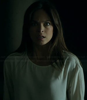 Cat’s white top with mesh sleeve panels on Beauty and the Beast