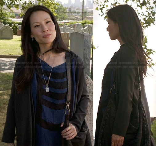 Joan’s blue and black stripe t-shirt dress and black purse on Elementary