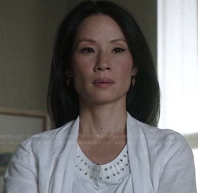 Joan’s white top with eyelet neckline one Elementary
