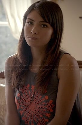 Sophie’s grey tank top with orange embroidered medallion on The Originals