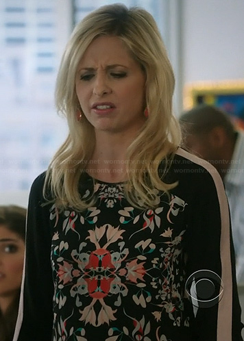 Sydney’s black floral print blouse with striped sleeves on The Crazy Ones