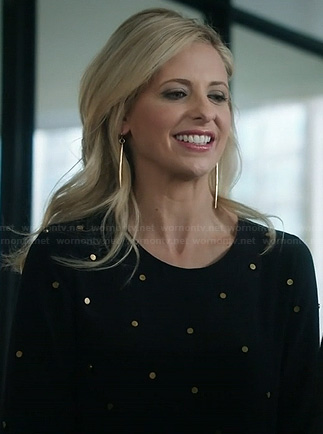 Sydney’s black and gold polka dot studded dress and gold dagger earrings on The Crazy Ones
