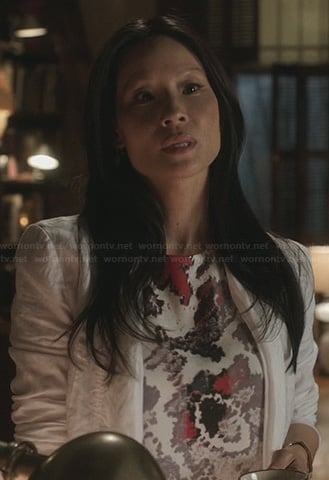 Joan’s white top with abstract pink print on Elementary