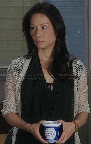 Joan’s black draped wrap dress and perforated cardigan on Elementary