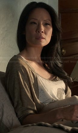 Joan’s baseball tee with orange bird graphic in bed on Elementary