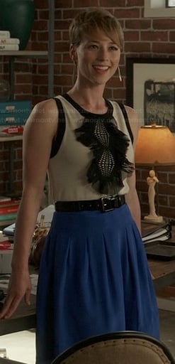 Margaux’s black and white ruffle front top and blue pleated skirt on Revenge