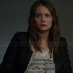 Thea’s musical notes print t-shirt and black jacket with white trim on Arrow