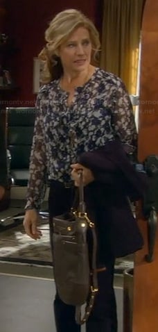 Vanessa’s blue floral blouse, elbow patch blazer and black bag on Last Man Standing