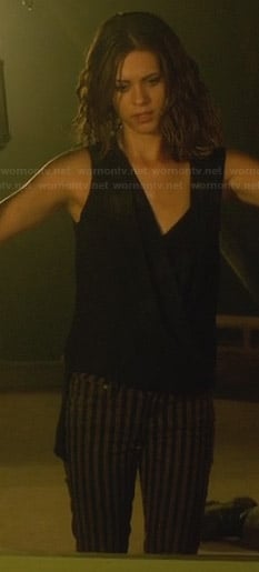 Alex’s striped jeans and black crossover top on Nikita