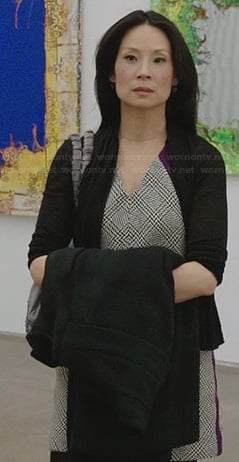 Joan’s houndstooth print dress with purple detail on Elementary