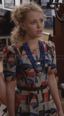 Carrie’s red and blue geometric patterned dress with leather trim on The Carrie Diaries