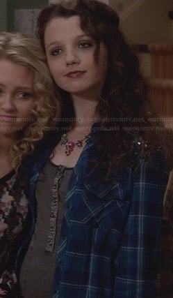 Dorrit’s grey button up dress and blue plaid shirt with studded shoulders on The Carrie Diaries