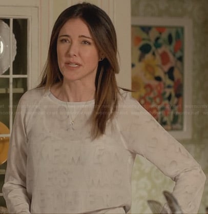 Ellie’s white sweatshirt with faded letter print on Cougar Town