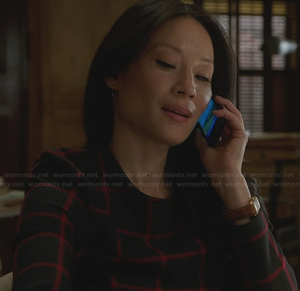 Joan’s navy and red checked long sleeve top on Elementary
