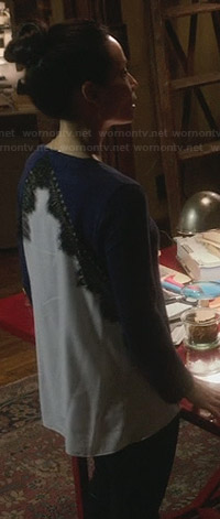 Joan’s navy top with white back and lace detail on Elementary